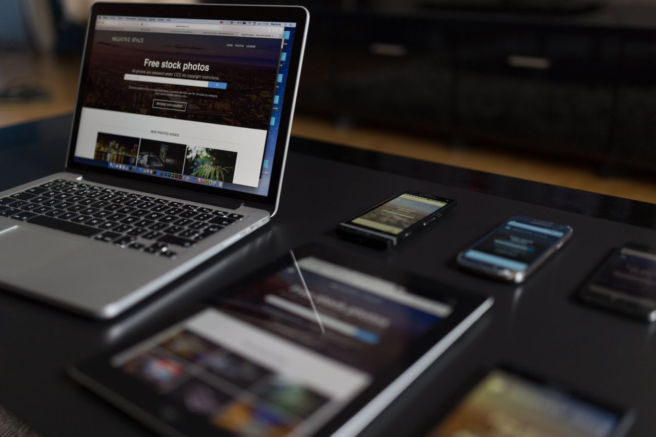 A modern workspace featuring a laptop, tablet, and smartphones, perfectly suited to tech and freelance work.